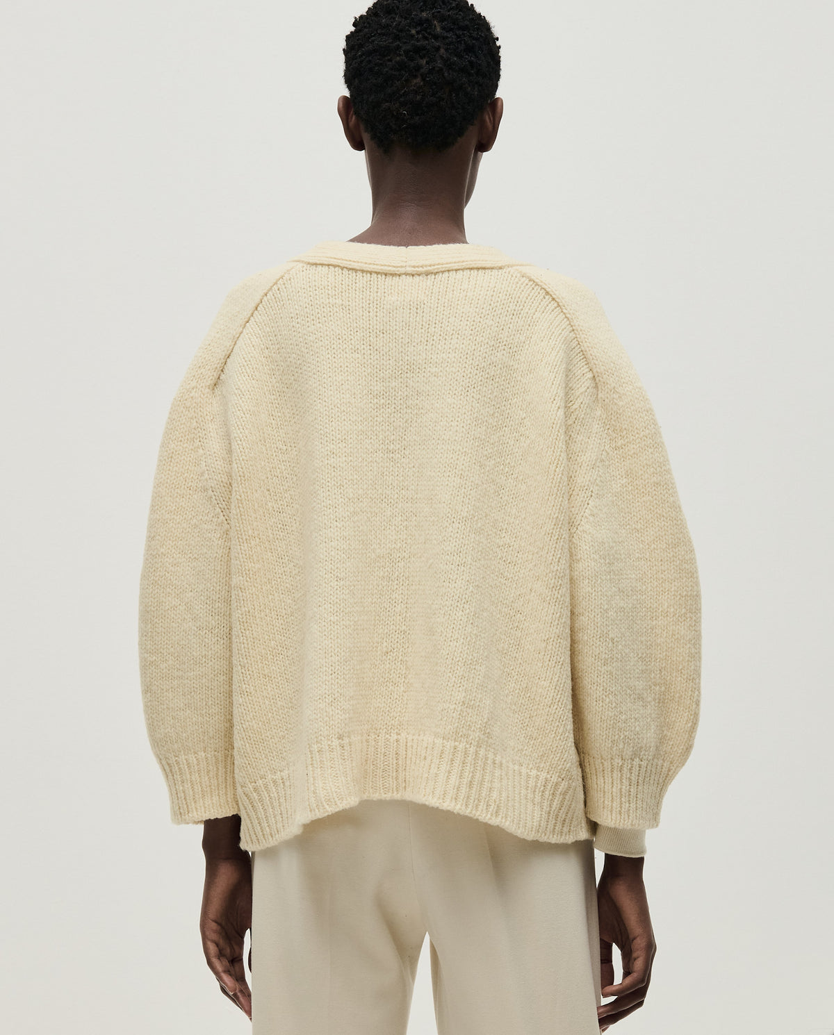 Babaà No51 natural women's cardigan, soft knit fabric with button closure, styled open on a model.