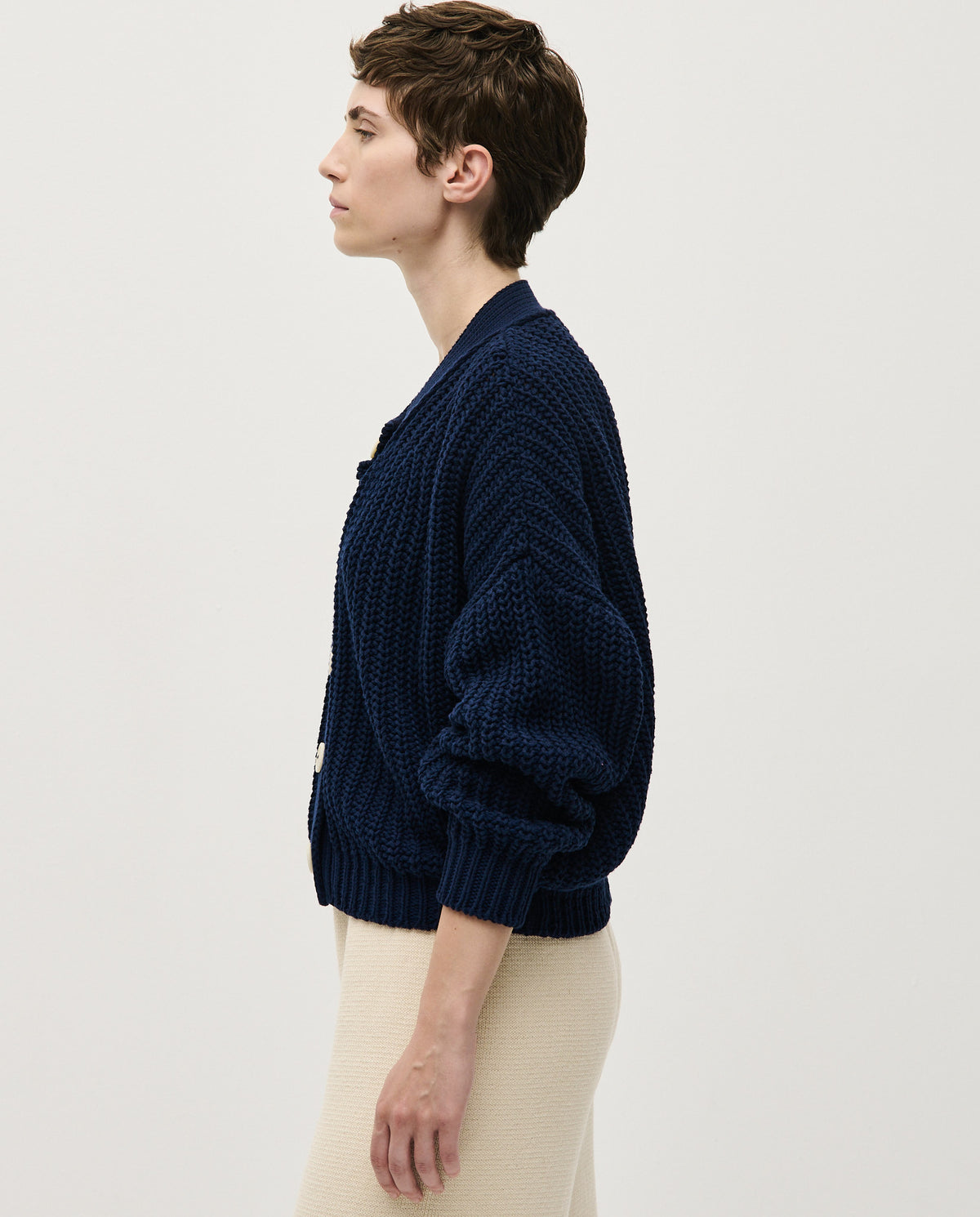Navy Babaà No8 women's cardigan featuring a cozy knit fabric and button-up front, displayed on a hanger.