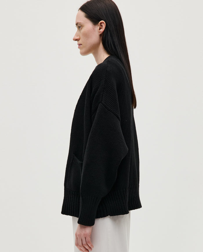 Black Babaà No86 cardigan for women, featuring a cozy knit design and button closure, shown on a model.