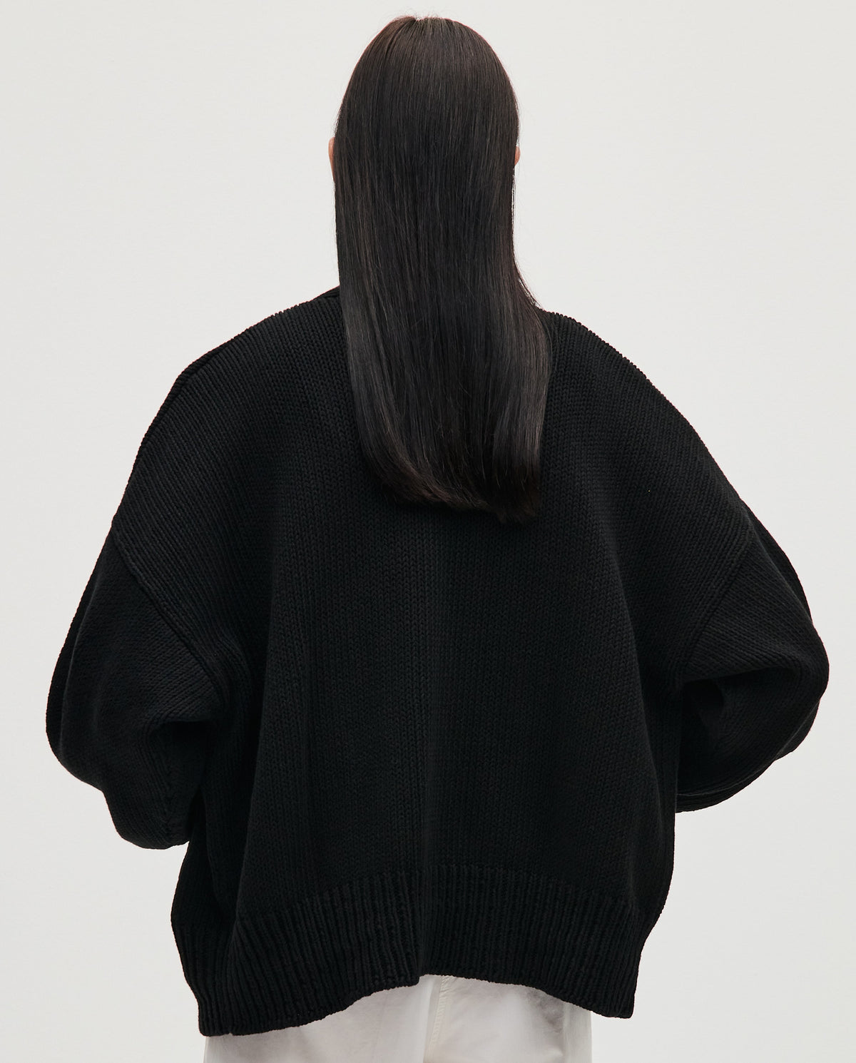 Black Babaà No86 women's cardigan displayed on a model, featuring a cozy knit sweater with a relaxed fit.