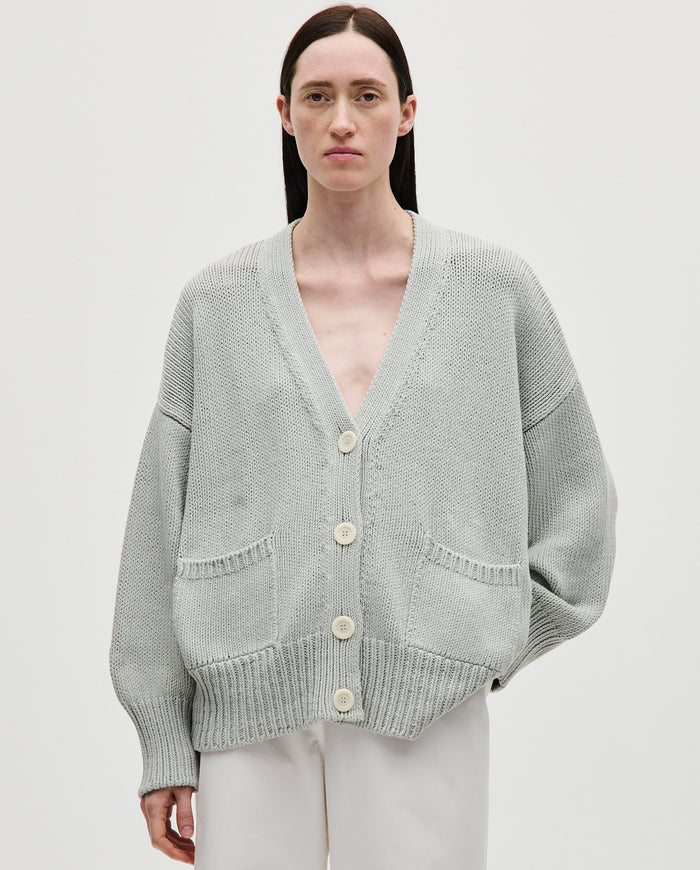 Babaà No86 chalk-colored women's cardigan displayed on a hanger, featuring a soft knit fabric and classic design.