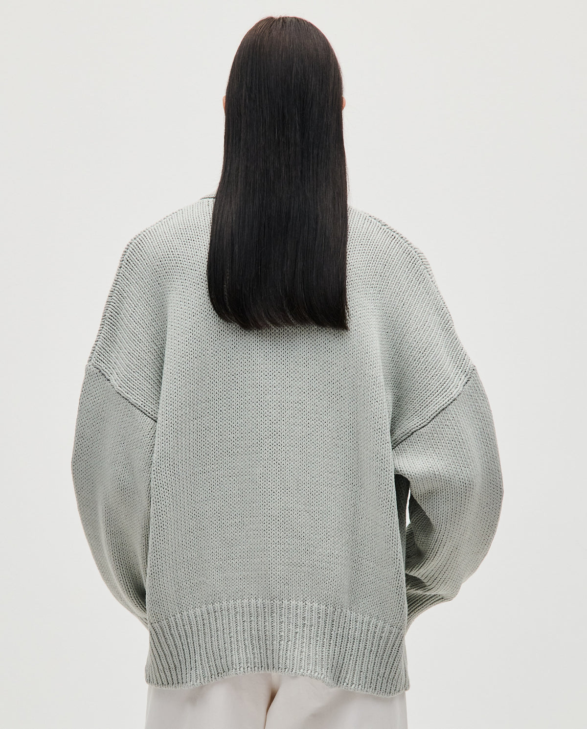 Babaà No86 chalk-colored women's cardigan, soft knit fabric, button-up front, and long sleeves, displayed on a hanger.