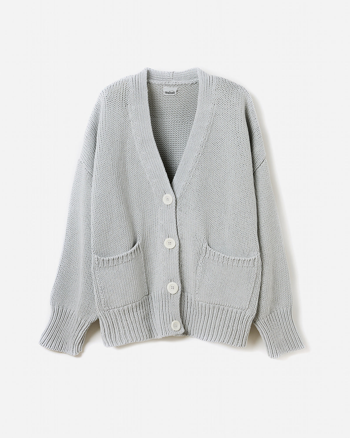 Silhouette of a woman wearing the Babaà No86 Chalk cardigan, showcasing its relaxed fit and soft knit fabric.