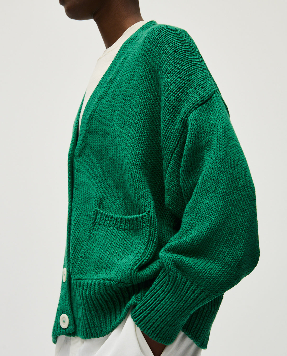 Woman wearing Babaà No86 Tree Fern cardigan, soft knit with leafy green tree fern pattern, styled for casual wear.