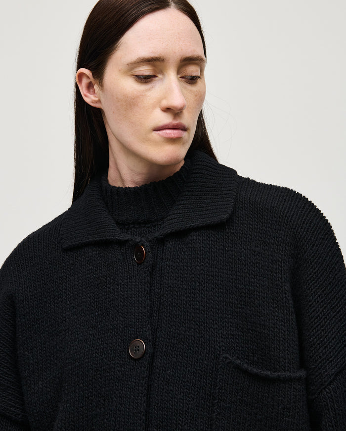 Black women's Babaà No93 cardigan with a cozy knit design, displayed on a hanger.
