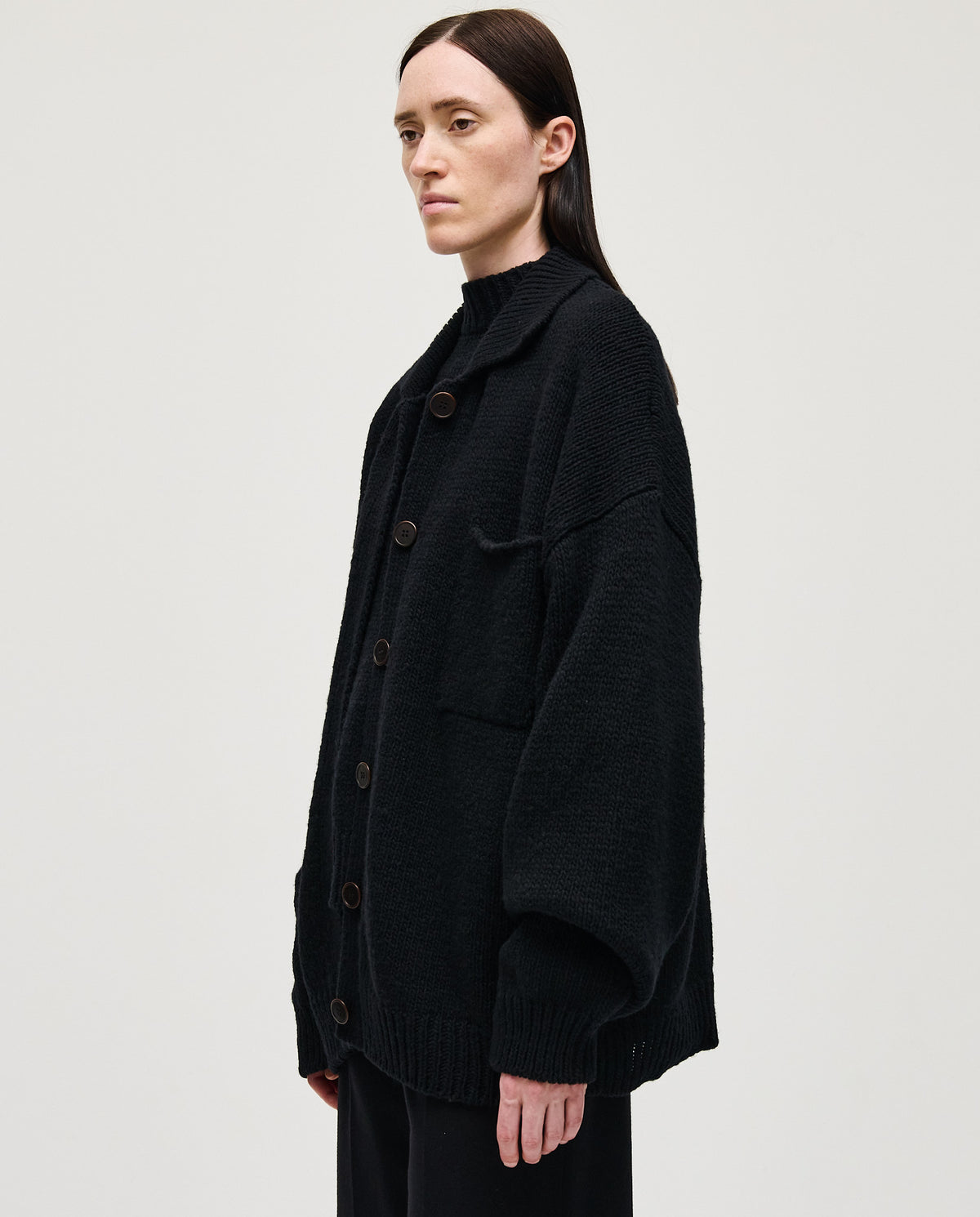 Black Babaà No93 women's cardigan displayed on a hanger, showcasing its soft fabric and relaxed fit.