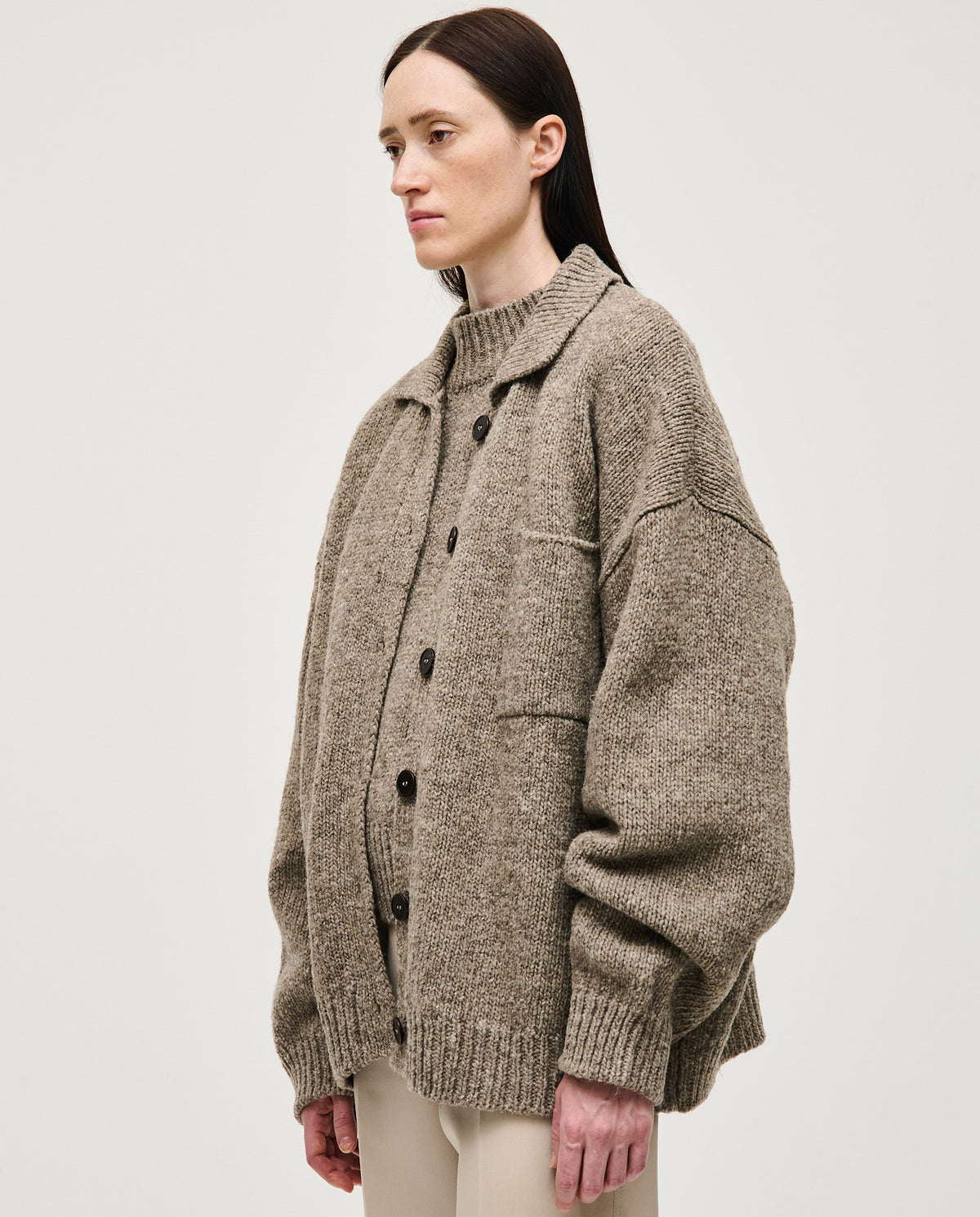 Babaà No93 dark mist women's cardigan displayed on a hanger, featuring a soft knit fabric and a relaxed fit.
