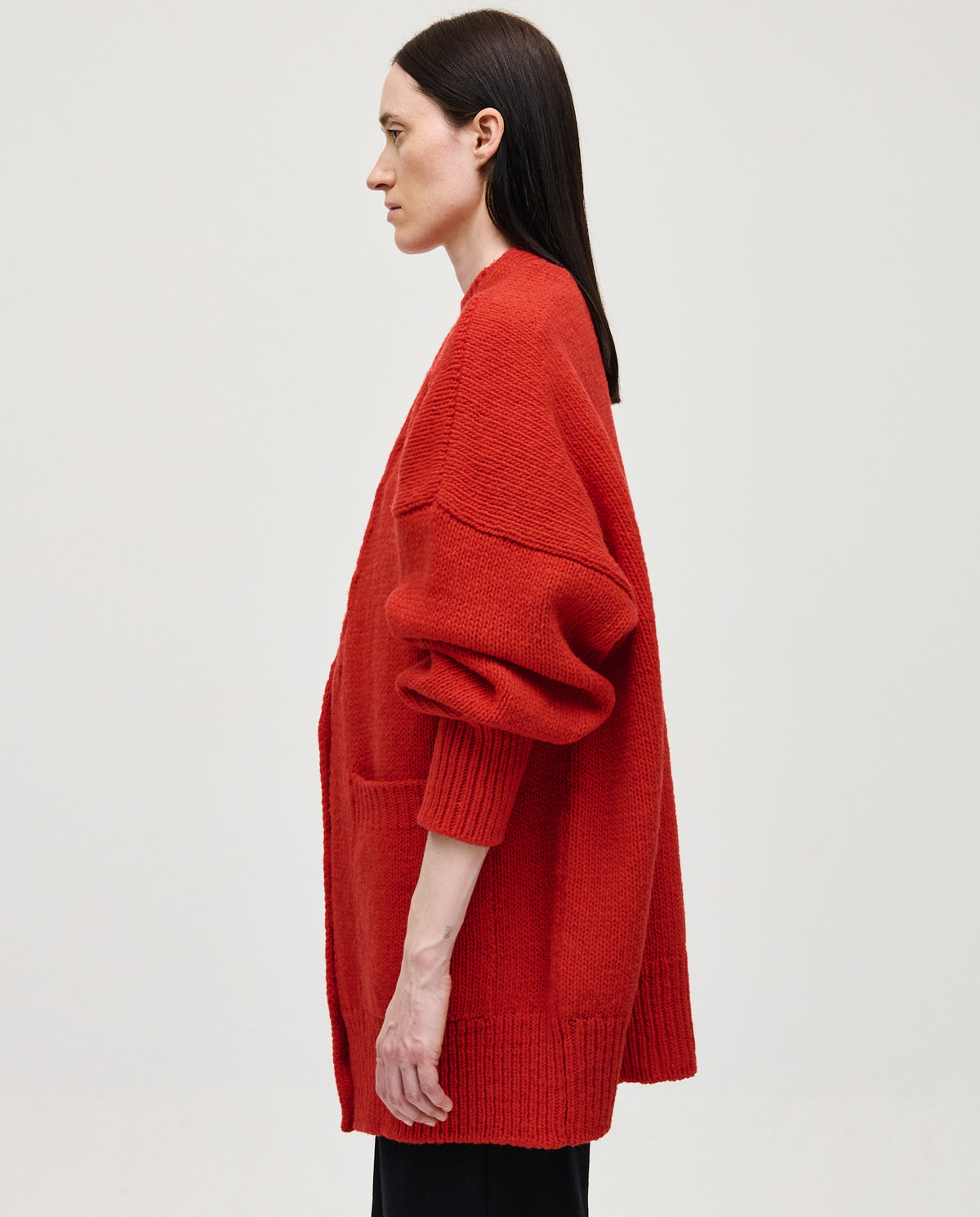 Red Babaà No17 women's coat displayed on a hanger with a sleek, tailored design and vibrant color.