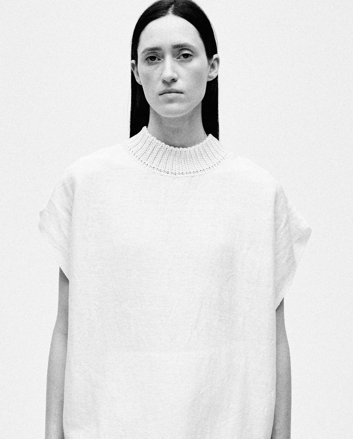 White Babaà Dress No60 worn by a woman, showcasing a stylish, elegant design with flowing fabric and comfortable fit.