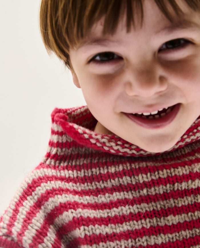 Babaà kids jumper No6 Ruby in vibrant red, soft knit fabric, worn by a child, showcasing cozy winter clothing for children.