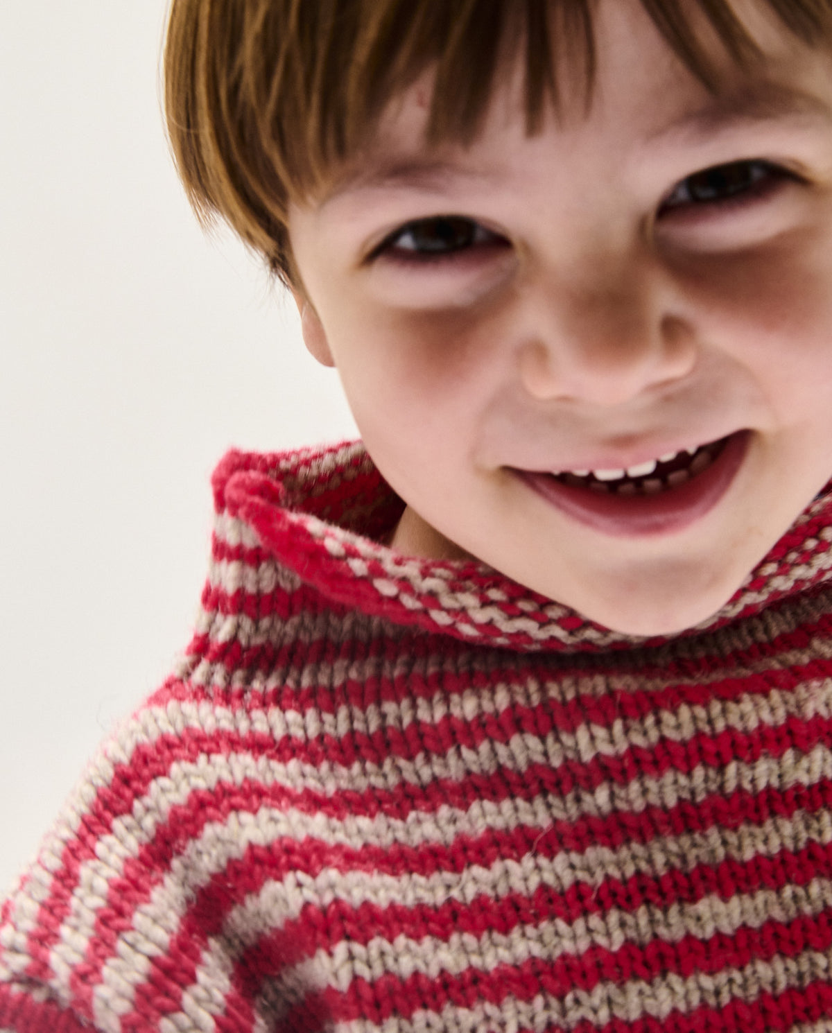 Babaà kids jumper No6 Ruby in vibrant red, soft knit fabric, worn by a child, showcasing cozy winter clothing for children.