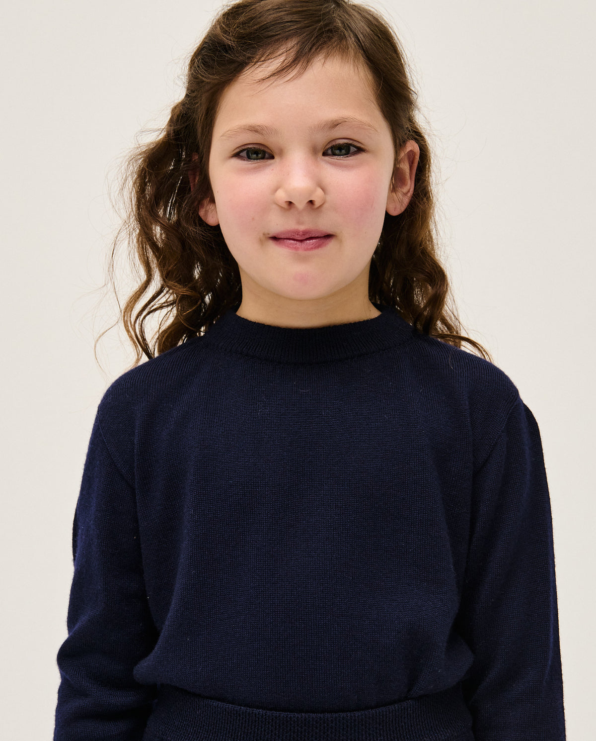 Navy kids jumper No25 by babaà, featuring a cozy knit design suitable for children, shown on a child modeling the sweater.