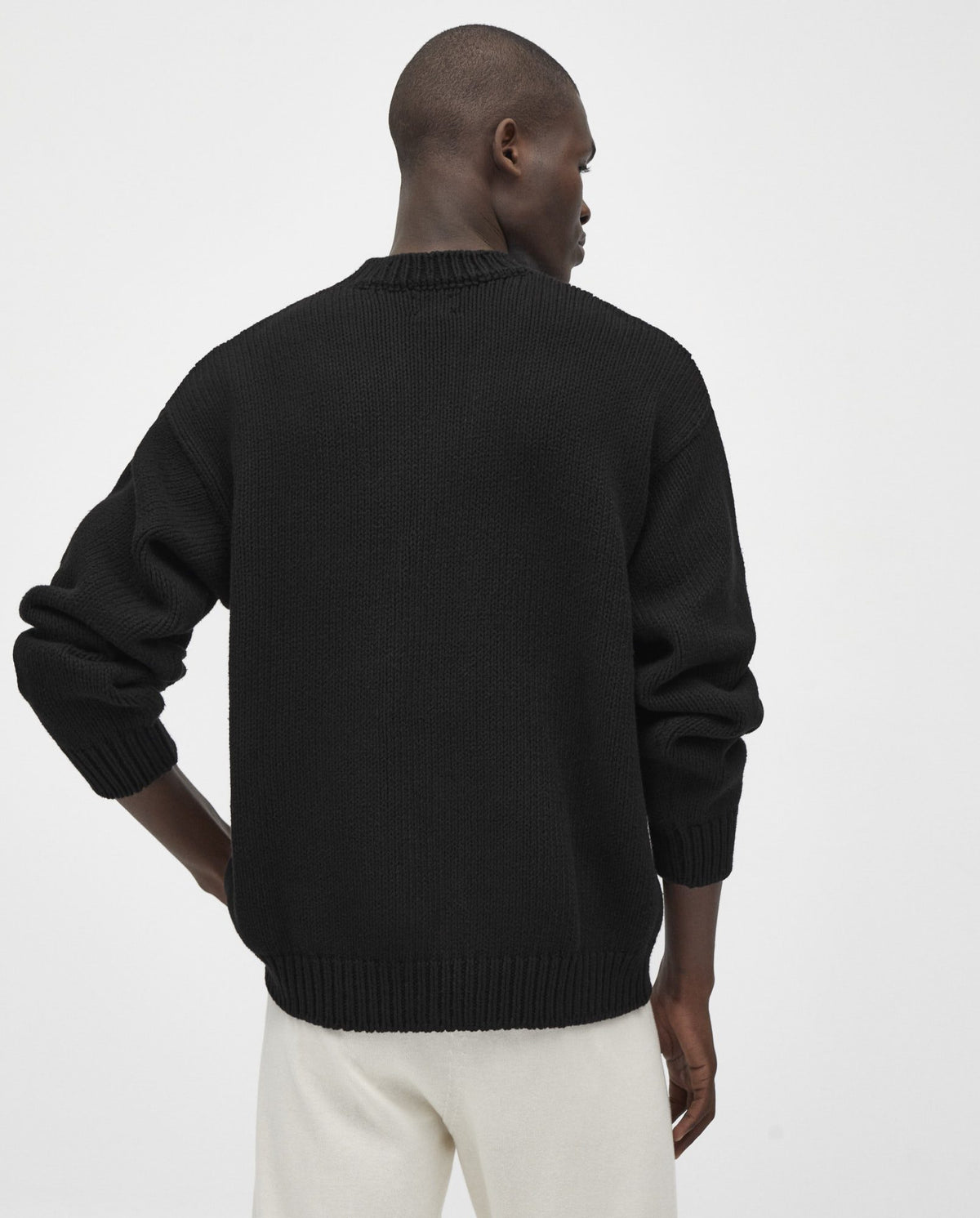 Black men's jumper No16 by Babaà, showcasing a cozy, stylish knit sweater with a round neckline and textured fabric.