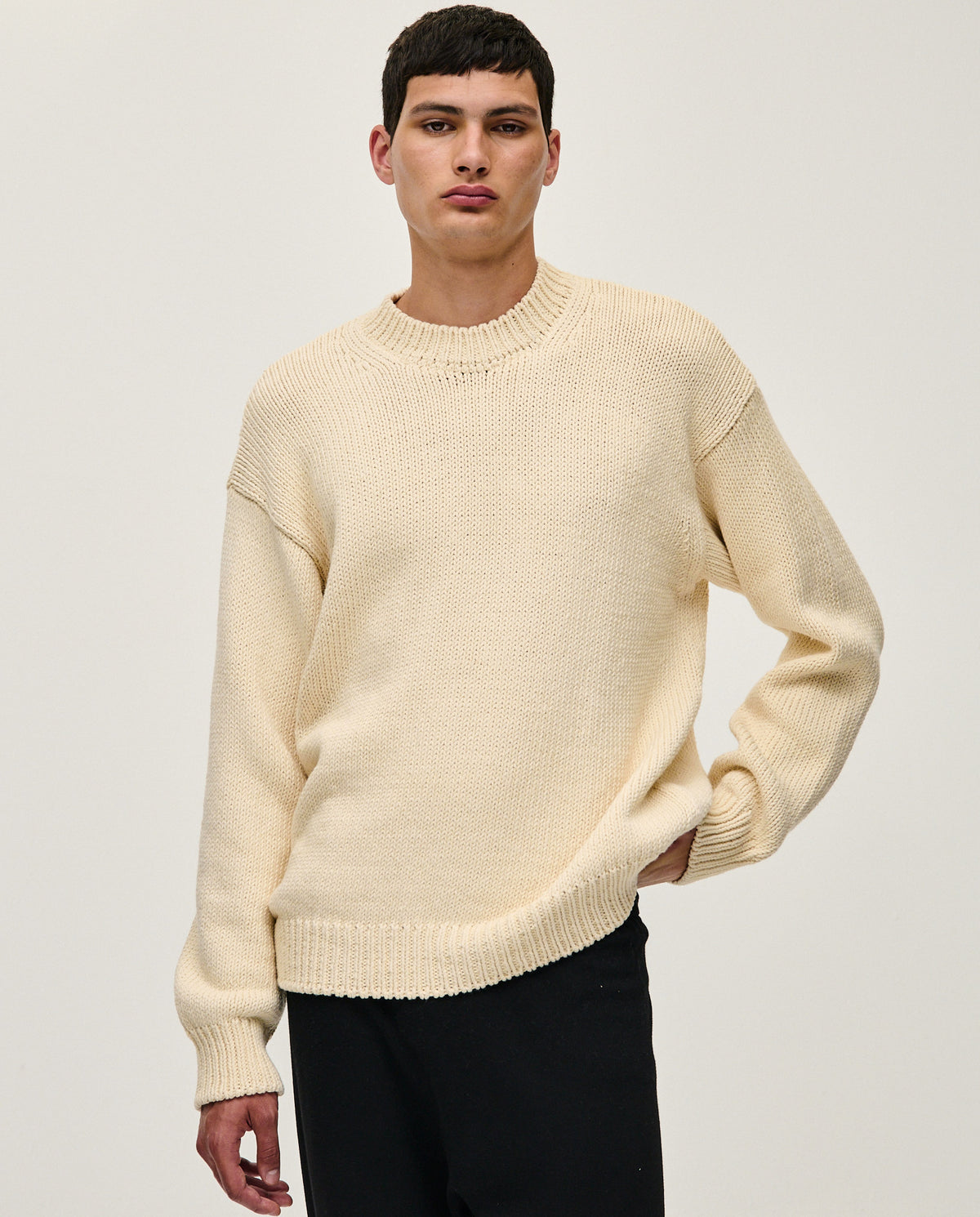 Natural beige Babaà No16 men's jumper displayed on a hanger, showcasing its soft fabric and classic fit.