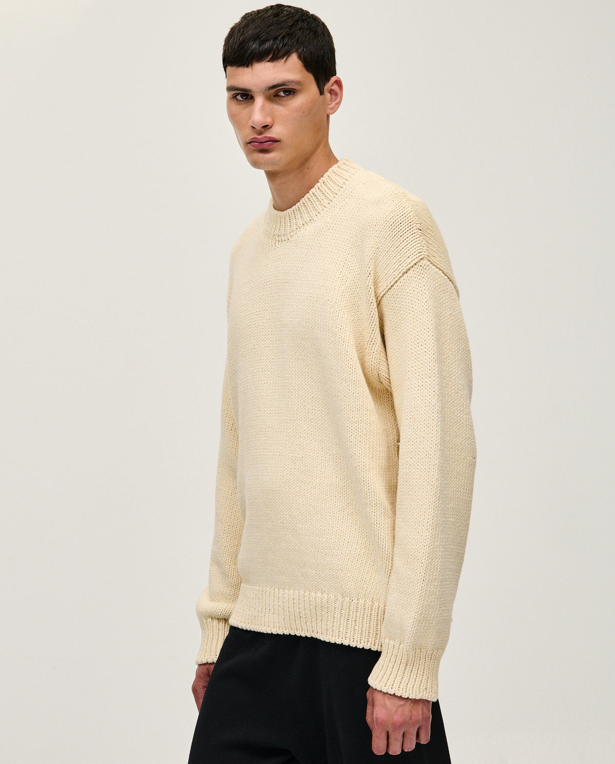 Natural beige Babaà No16 men's jumper displayed on a hanger, showcasing its soft knit fabric and classic fit.
