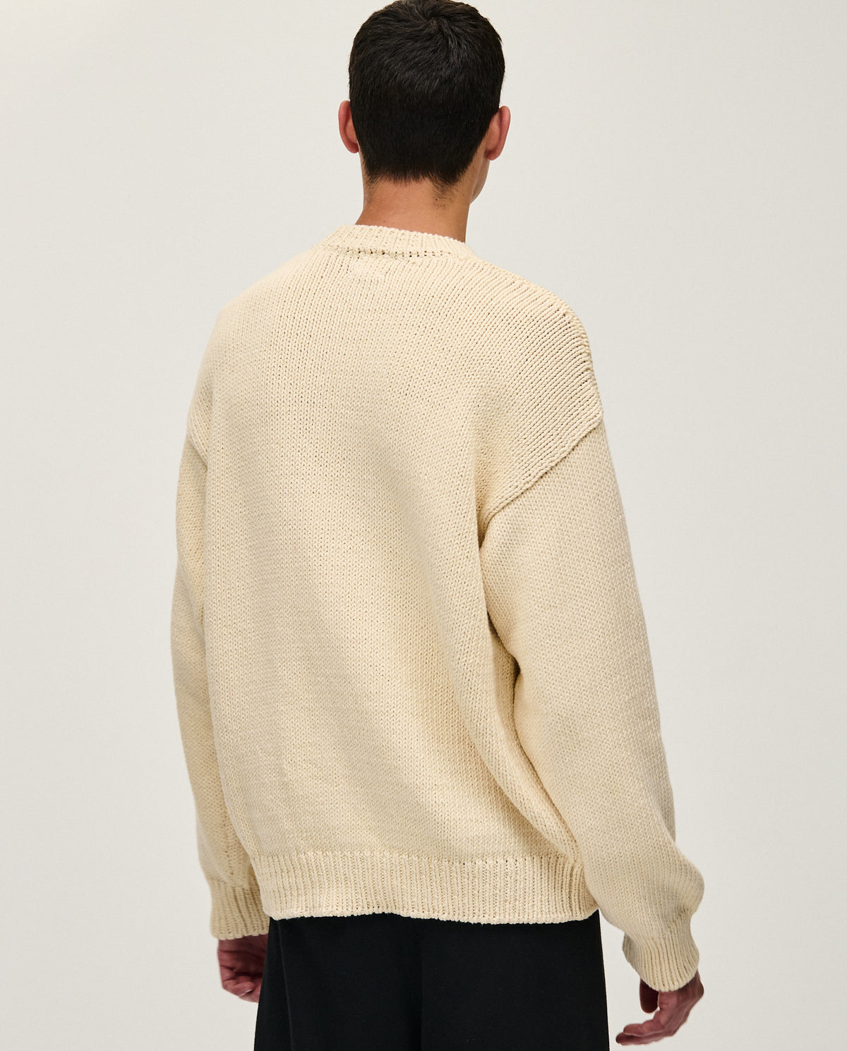 Man wearing Babaà No16 Natural jumper, showcasing a cozy, natural-colored knit sweater with a relaxed fit.
