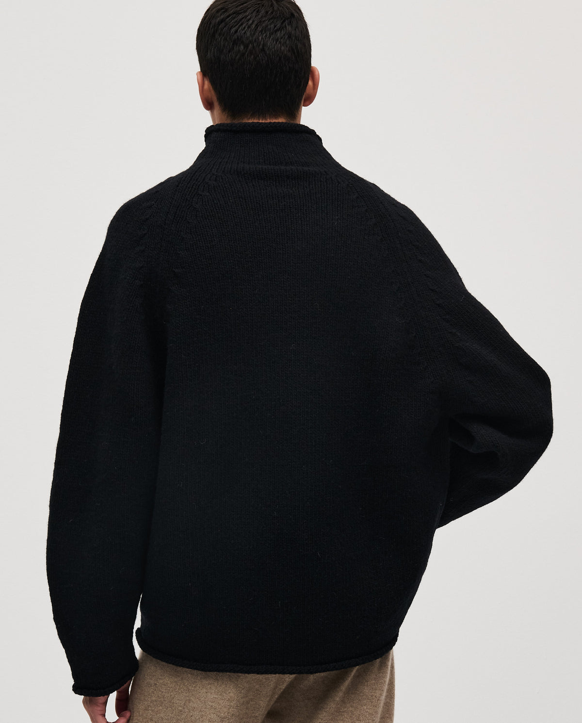 Black Babaà No81 men's jumper displayed on a model, showcasing its stylish fit and cozy knit fabric.