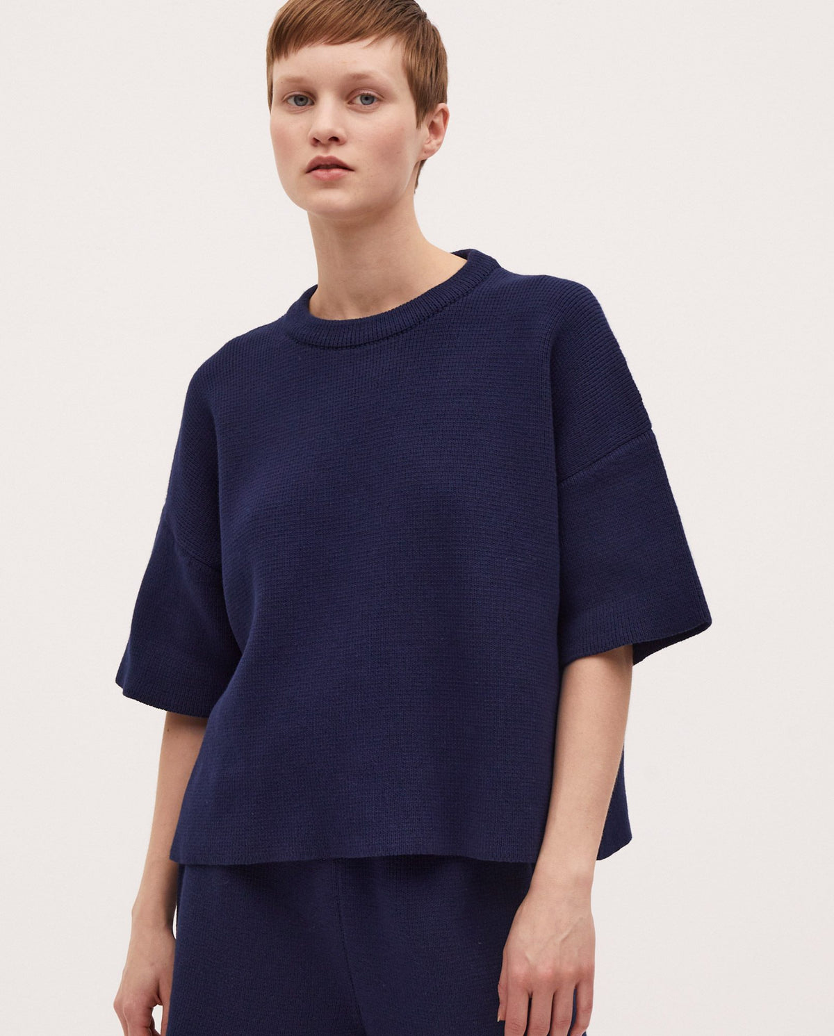 Navy jumper No35 by Babaà, featuring a cozy knit fabric and classic crew neck design, displayed on a hanger.