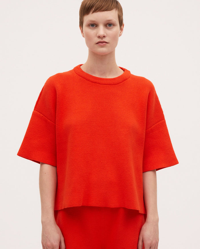 Babaà No35 Tangelo jumper featuring a cozy, vibrant orange knit design for children.