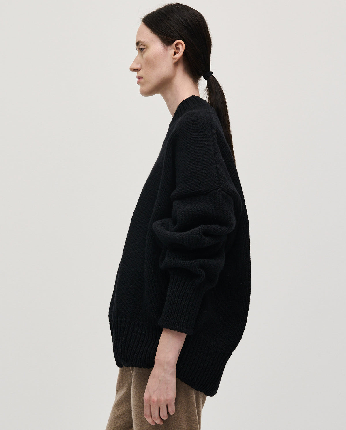 Black Babaà No11 jumper worn by woman, featuring a cozy, stylish knit design perfect for casual or layered outfits.