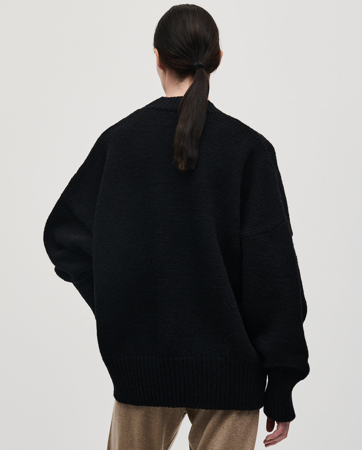 Black Babaà No11 jumper worn by a woman, featuring a cozy knit design and a relaxed fit.