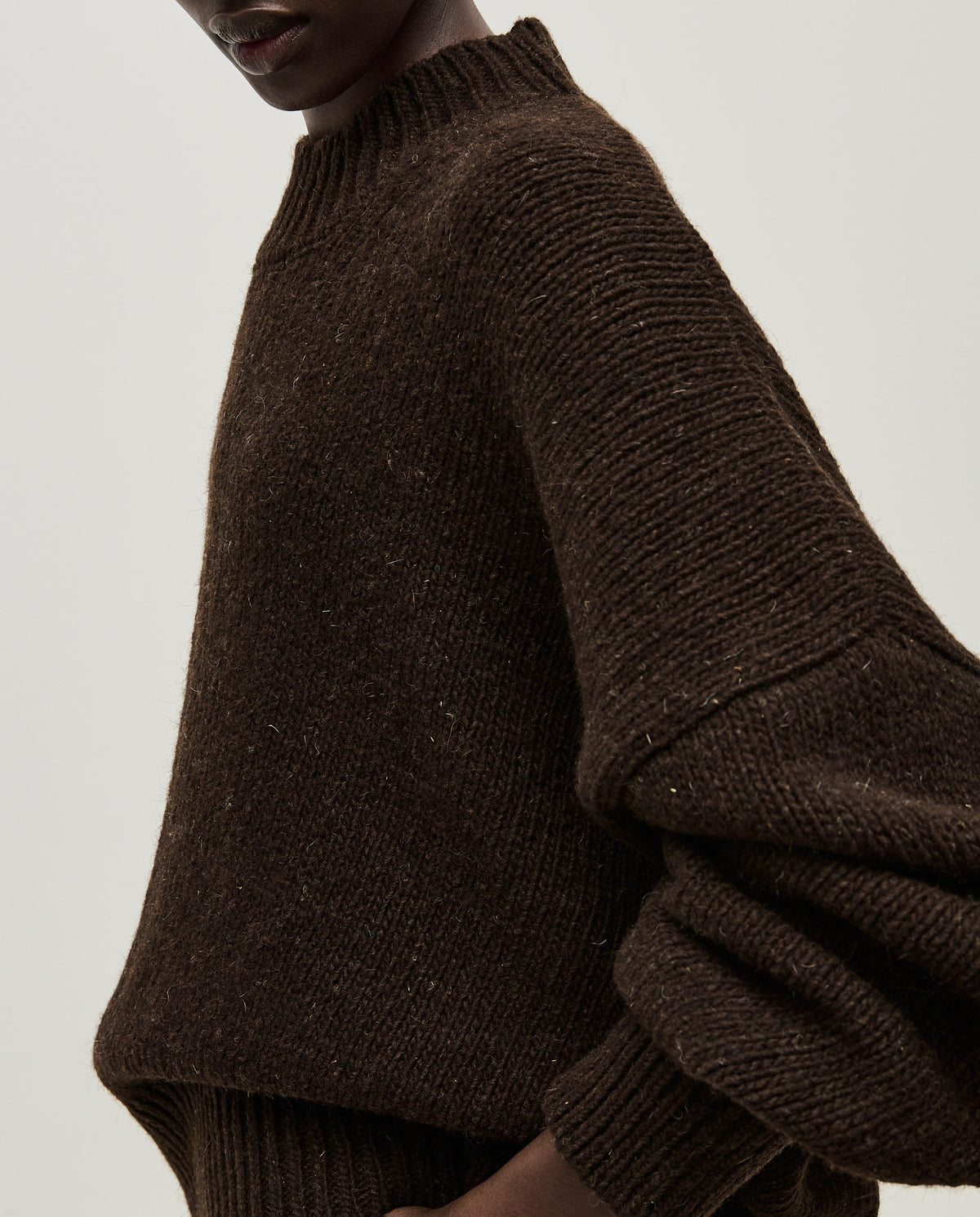 Babaà No11 Earth women's jumper, cozy knit sweater in earthy tone, styled on a woman, showcasing casual winter fashion.