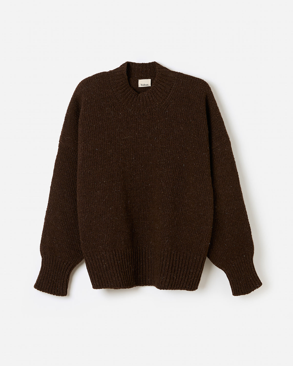 Babaà No11 Earth jumper worn by a woman, silhouette view showing a cozy, stylish knit sweater in earthy tones.