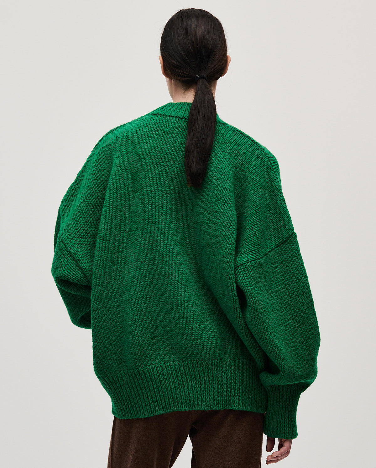 Babaà No11 emerald jumper worn by a woman, showcasing a cozy, stylish knit sweater in vibrant emerald green.