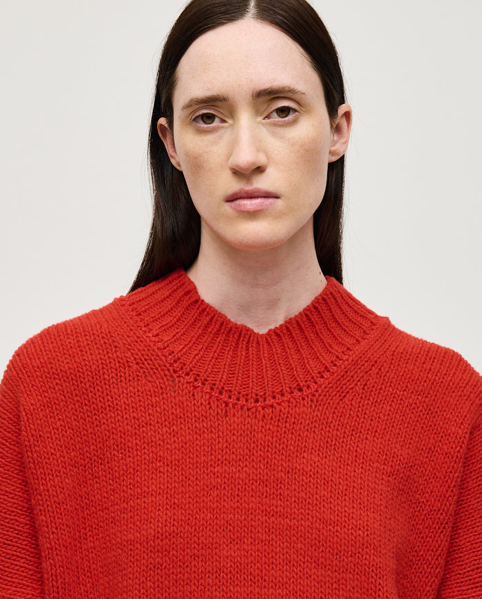 Red Babaà No11 women's jumper displayed on a model, showcasing a cozy, stylish knit sweater in vibrant red.