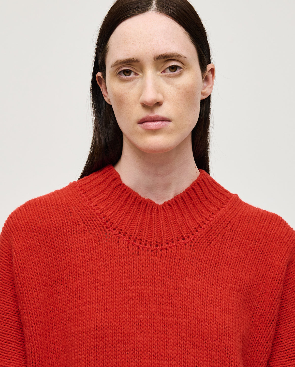 Red Babaà No11 women's jumper displayed on a model, showcasing a cozy, stylish knit sweater in vibrant red.