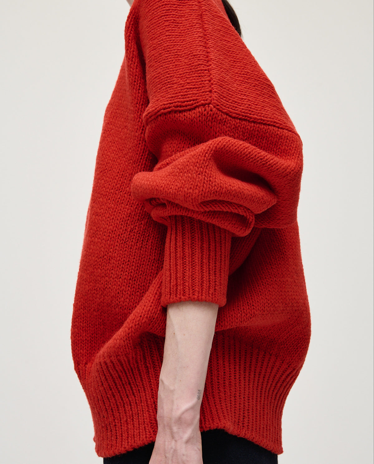 Red Babaà No11 women's jumper featuring a cozy, stylish design, shown on a model with a relaxed fit and soft fabric.