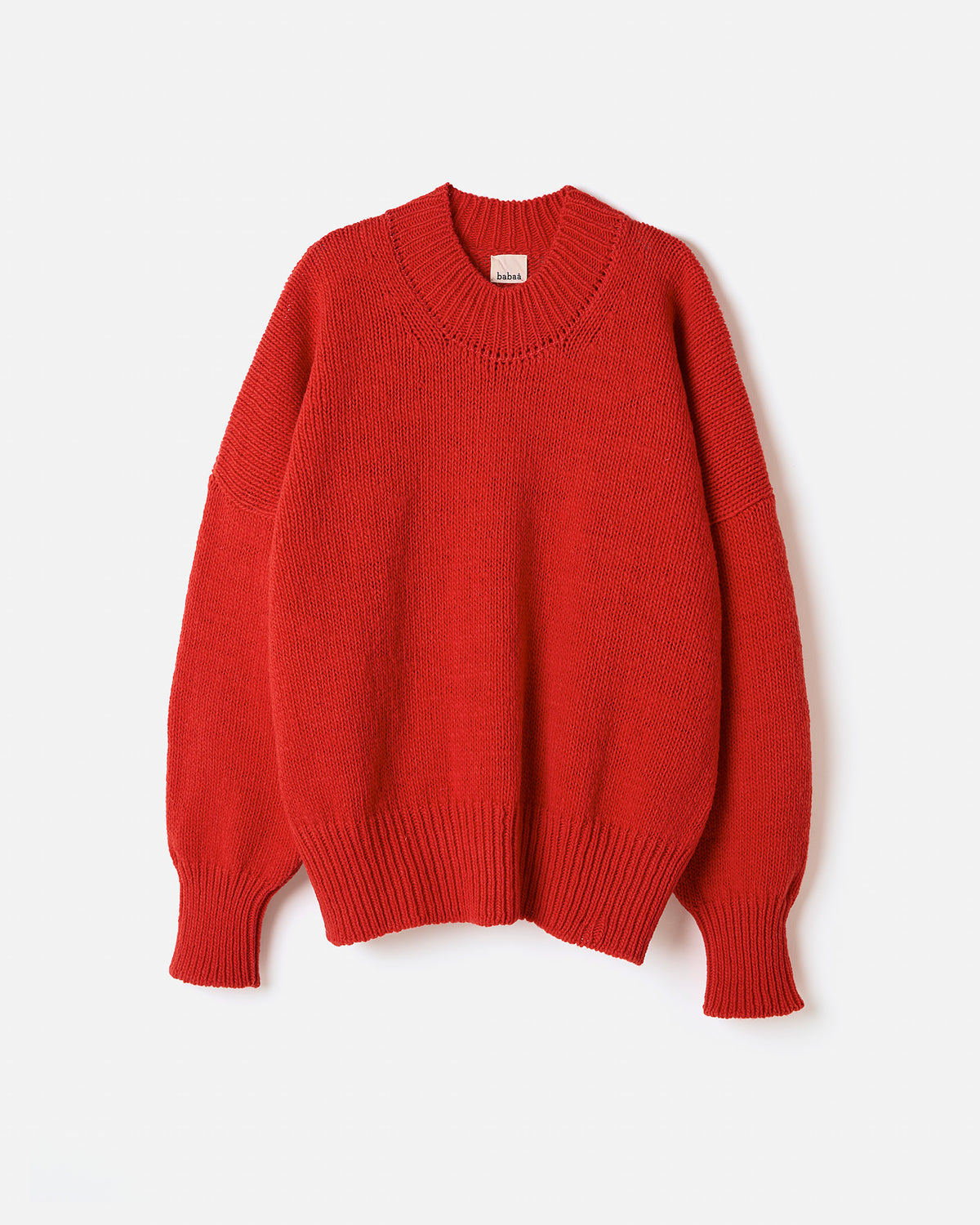 Red Babaà Jumper No11 worn by a woman, showcasing a stylish silhouette and comfortable fit in a natural pose.