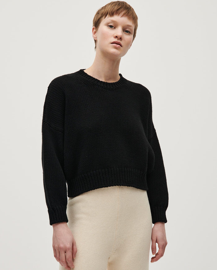 Black Babaà No14 jumper worn by a woman, featuring a cozy knit fabric and stylish design.