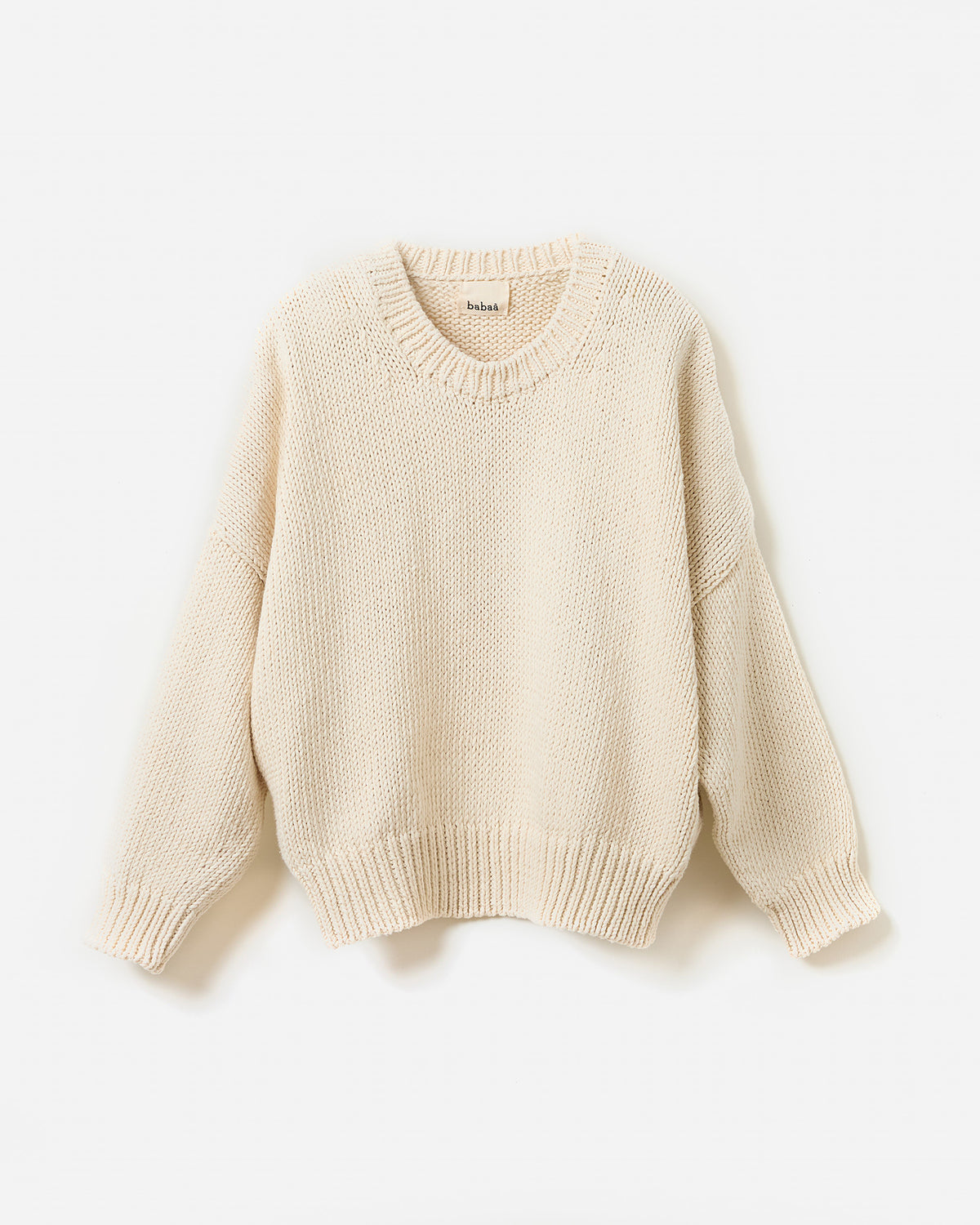Woman wearing Babaà No14 natural jumper, showcasing a casual, cozy knit sweater with a relaxed fit and soft texture.