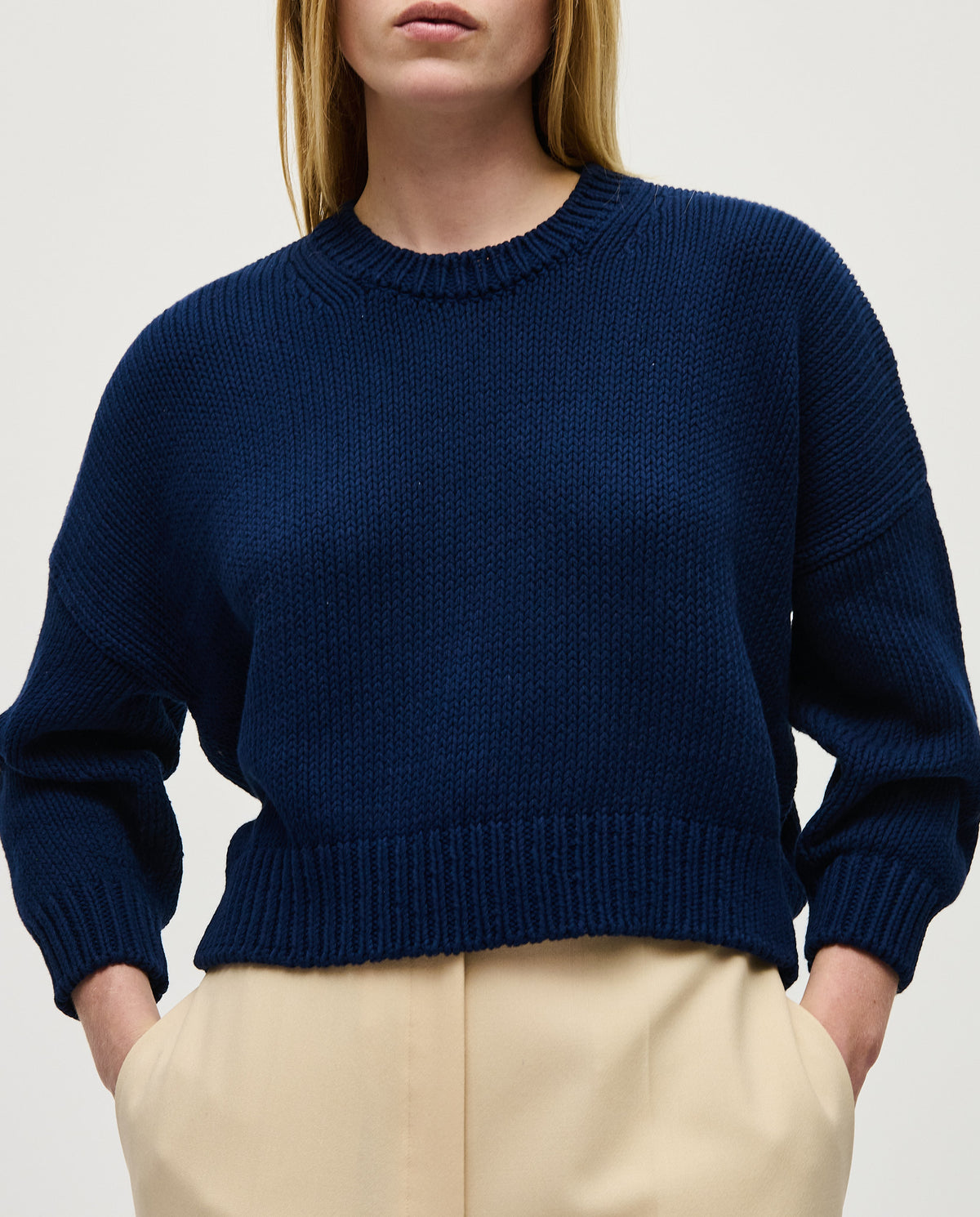 Navy jumper No14 by Babaà, worn by a woman, featuring a cozy knitted design and a relaxed fit.