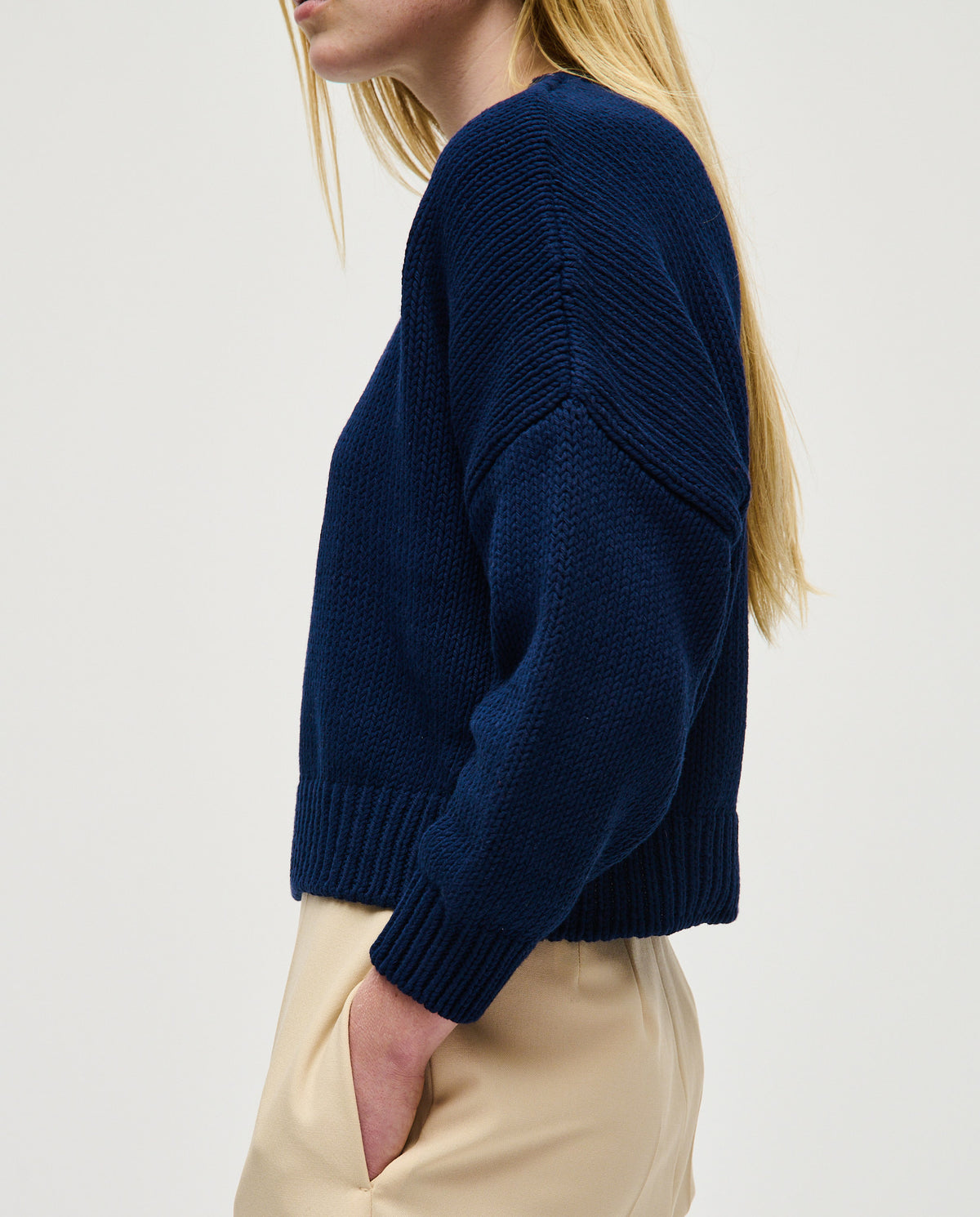 Navy jumper No14 by babaà, worn by a woman, featuring a cozy knit texture and a relaxed fit, ideal for casual wear.