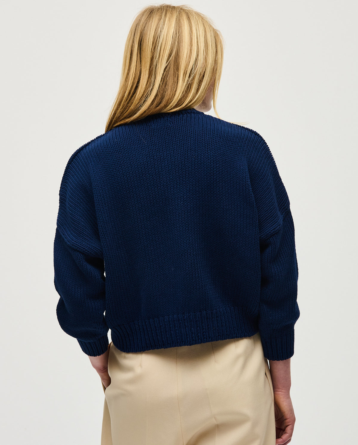 Navy jumper No14 by Babaà, worn by a woman, featuring a cozy knit fabric and a relaxed fit for casual style.