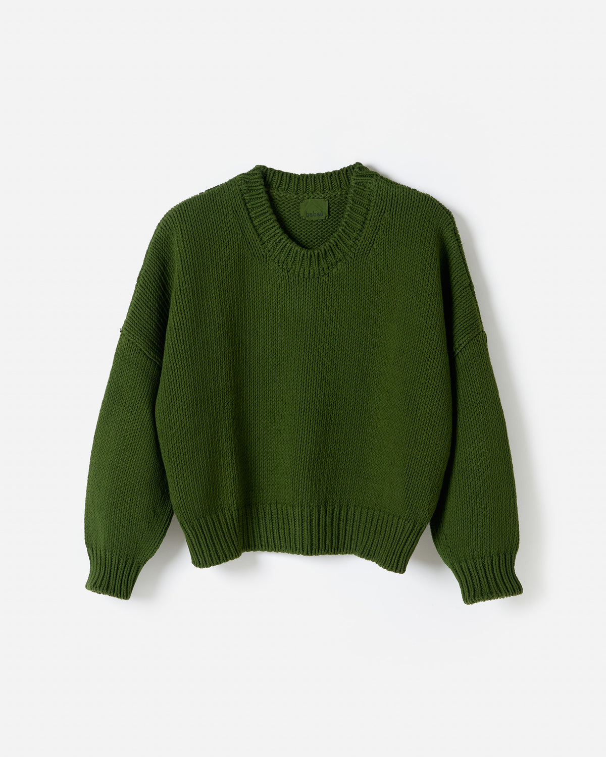 Silhouette of Babaà No14 Pine jumper worn by a woman, showcasing its cozy fit and stylish design in a natural pose.