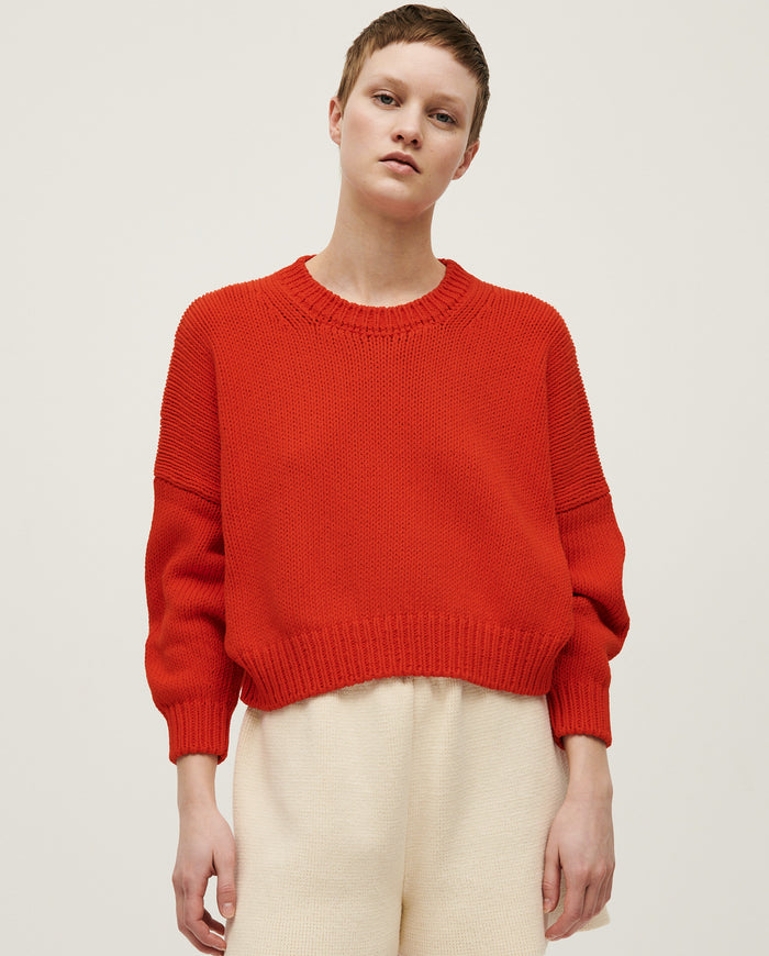 Babaà No14 Summer Flame jumper worn by a woman, featuring a vibrant flame-colored knit design and casual fit.