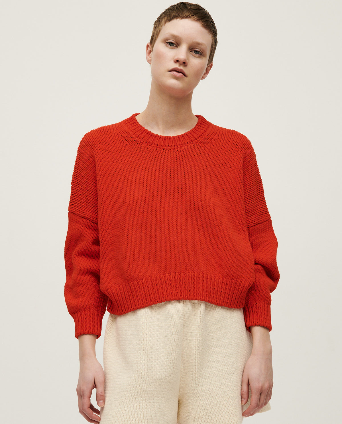 Babaà No14 Summer Flame jumper worn by a woman, featuring a vibrant flame-colored knit design and casual fit.