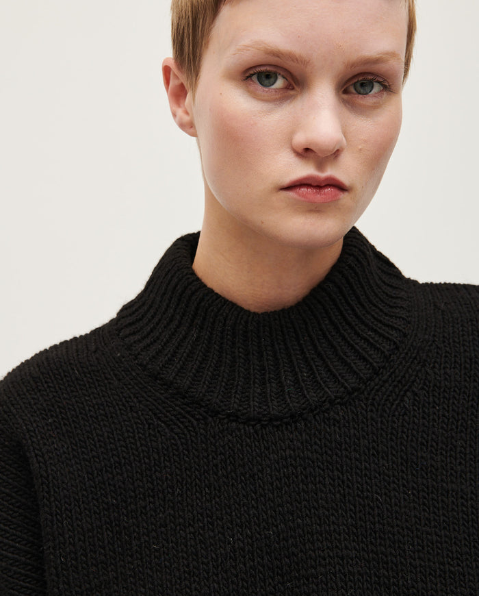 Black Babaà No15 jumper worn by a woman, featuring a cozy knit fabric and relaxed fit, perfect for casual styling.
