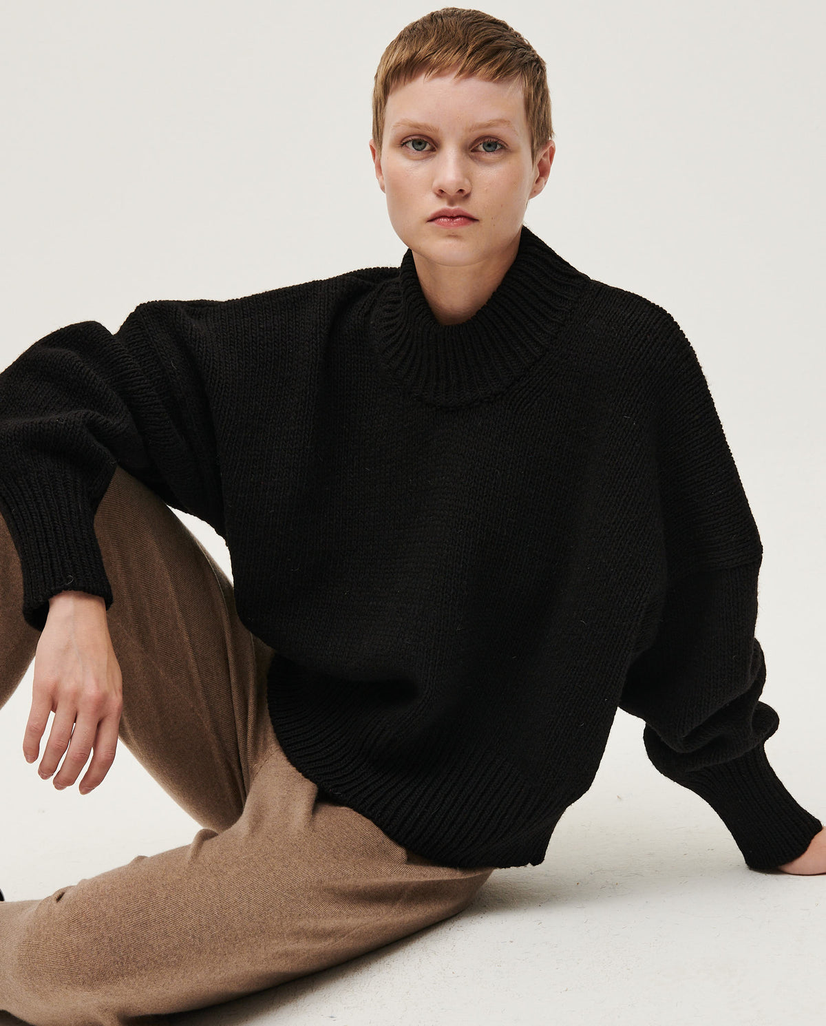 Black Babaà No15 women's jumper, cozy knit sweater with a relaxed fit, displayed on a model in a casual setting.