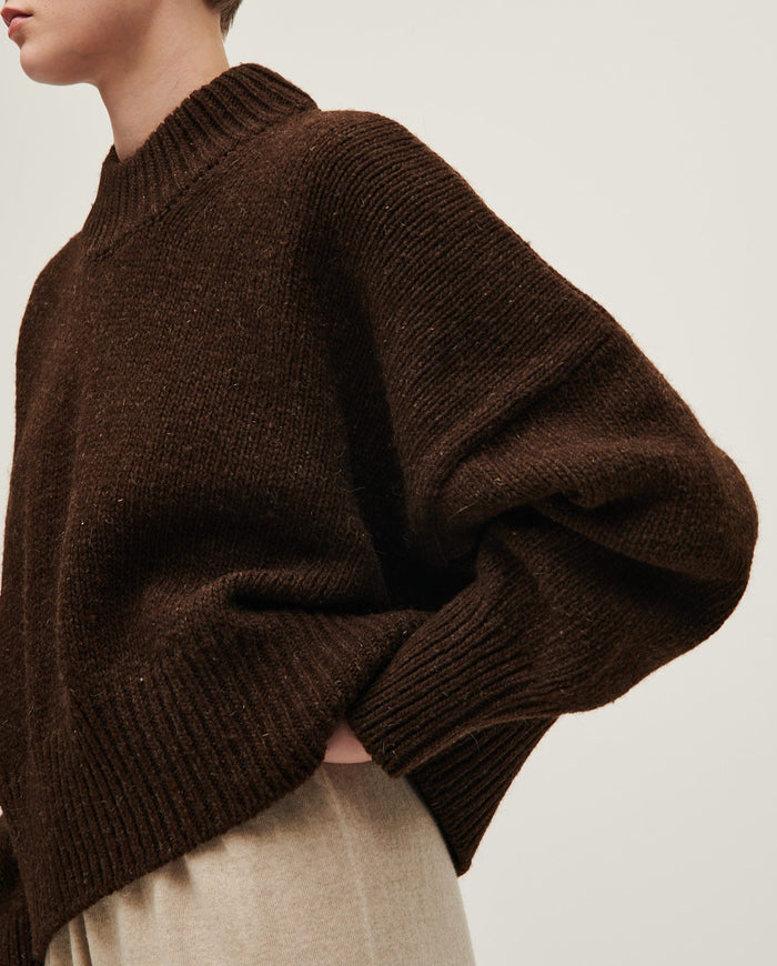 Woman wearing Babaà No15 Earth jumper in a cozy, earthy-toned knit sweater with a relaxed fit.