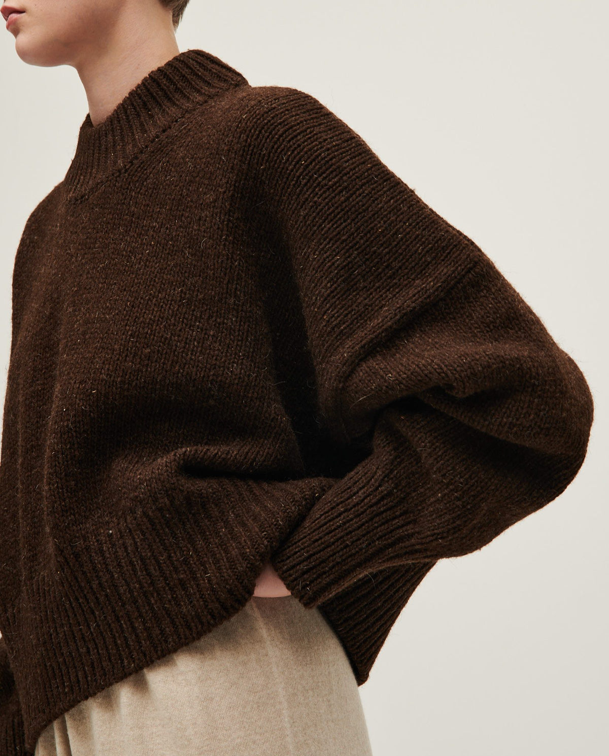 Woman wearing Babaà No15 Earth jumper in a cozy, earthy-toned knit sweater with a relaxed fit.