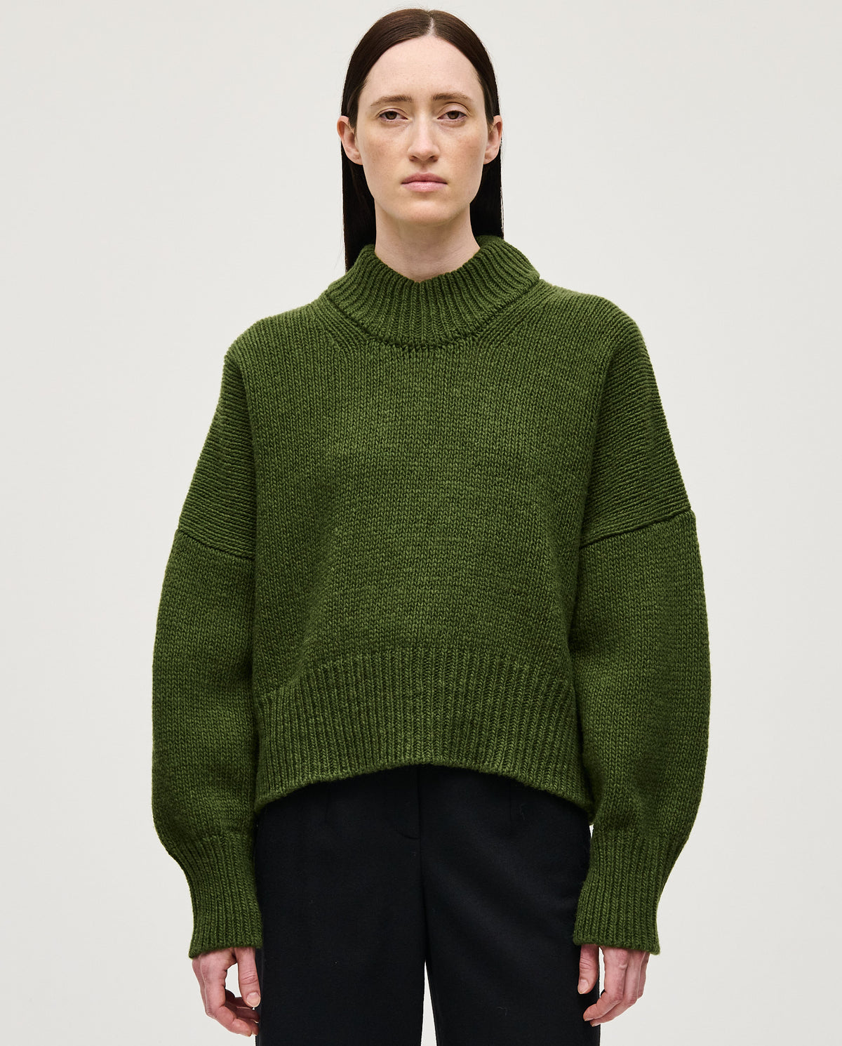 Woman wearing Babaà No15 Forest jumper, cozy knit sweater in forest green, styled casually with a relaxed fit.