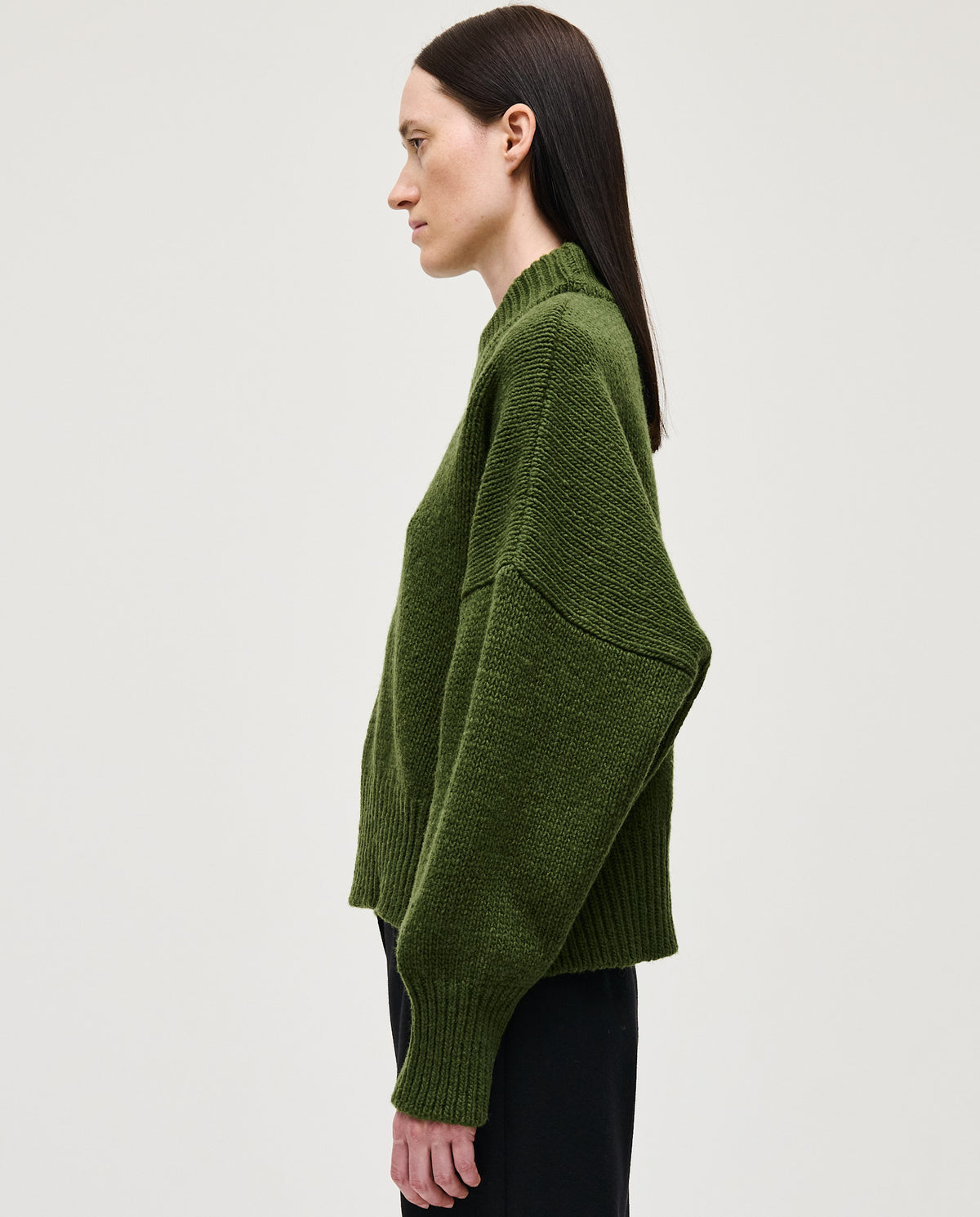 Woman wearing Babaà No15 Forest jumper, cozy green knitted sweater with a relaxed fit, suitable for casual autumn outfits.