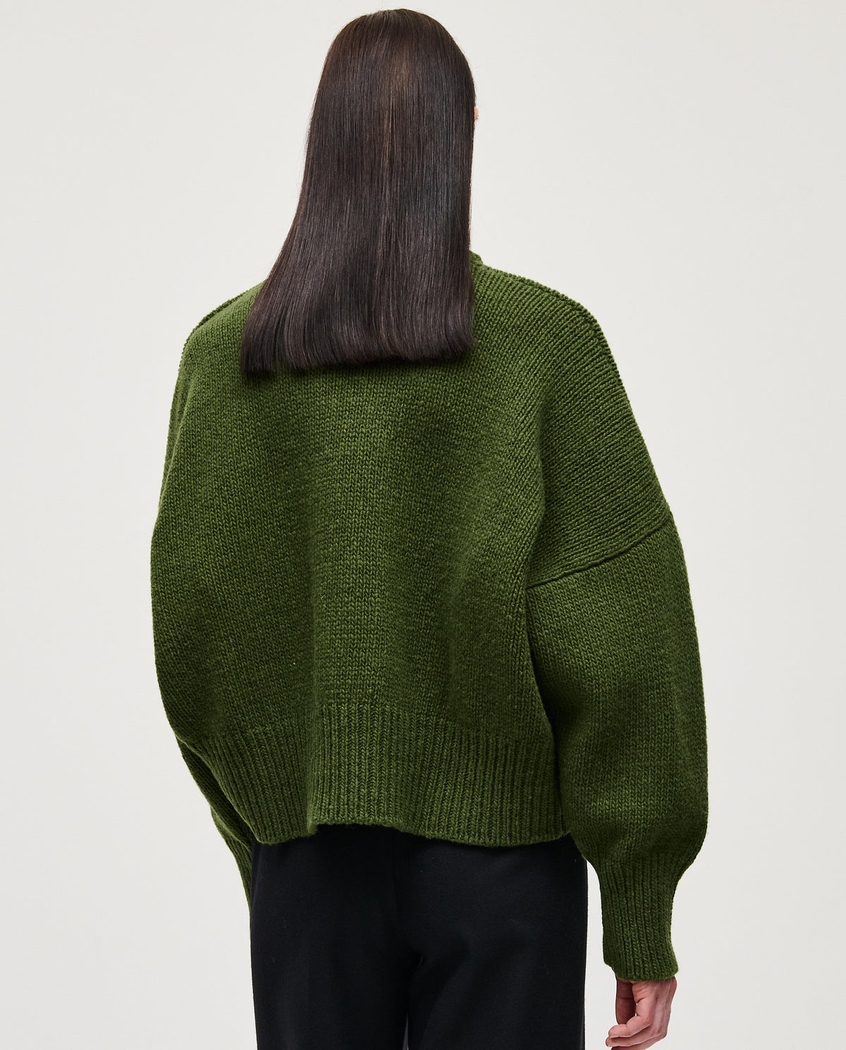 Woman wearing Babaà No15 Forest jumper, cozy knit sweater in forest green, styled for casual wear.