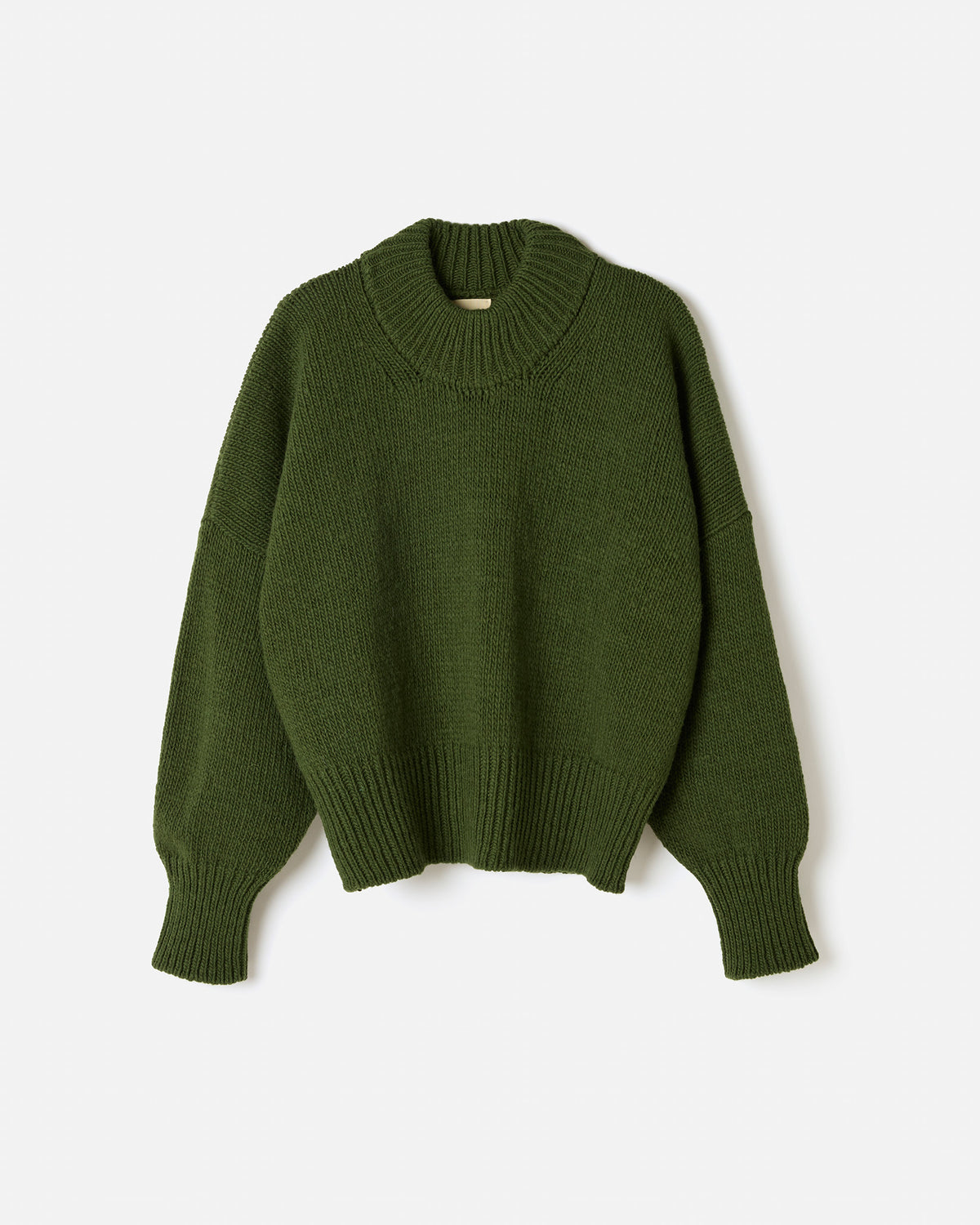 Woman wearing Babaà No15 Forest jumper, showcasing the cozy, forest-green knit in a stylish silhouette.