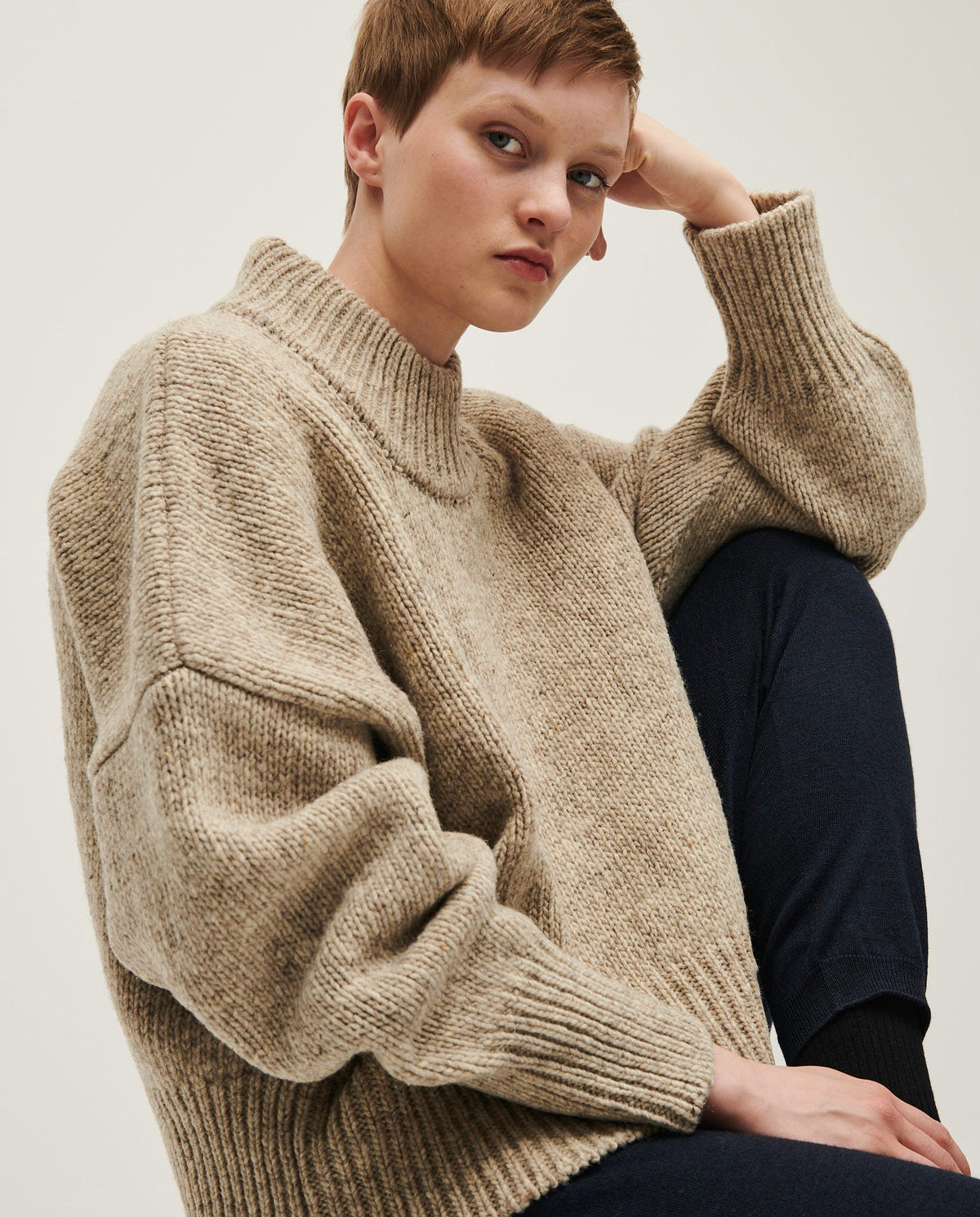Woman wearing Babaà No15 Mist jumper, soft knit sweater with a relaxed fit, featuring a stylish and cozy design.