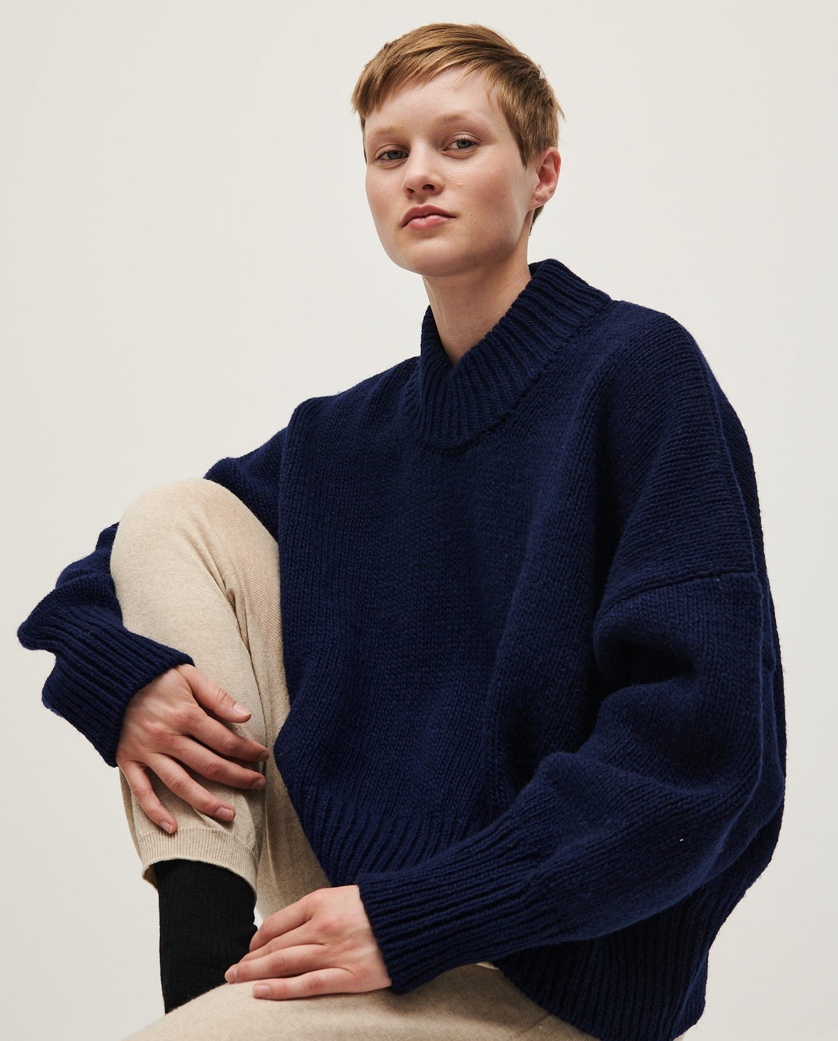 Navy Babaà no15 women's jumper with long sleeves and ribbed cuffs, styled on a woman against a neutral background.